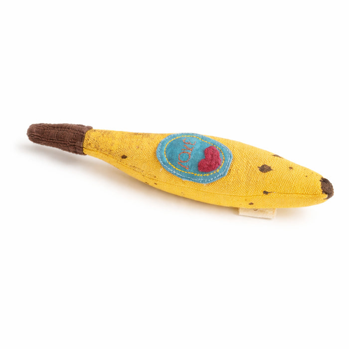 Yellow baby rattle toy resembling a banana with a blue patch and red heart on a white background