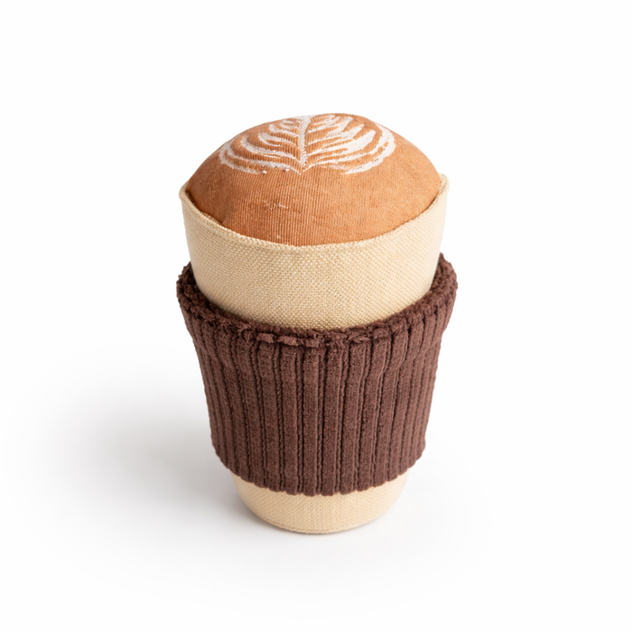 Handmade cappuccino cup baby rattle with embroidered latte art on white background