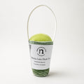 Matcha Latte Plush Toy baby rattle by normadot shown in studio on a light background with white paper packaging handle