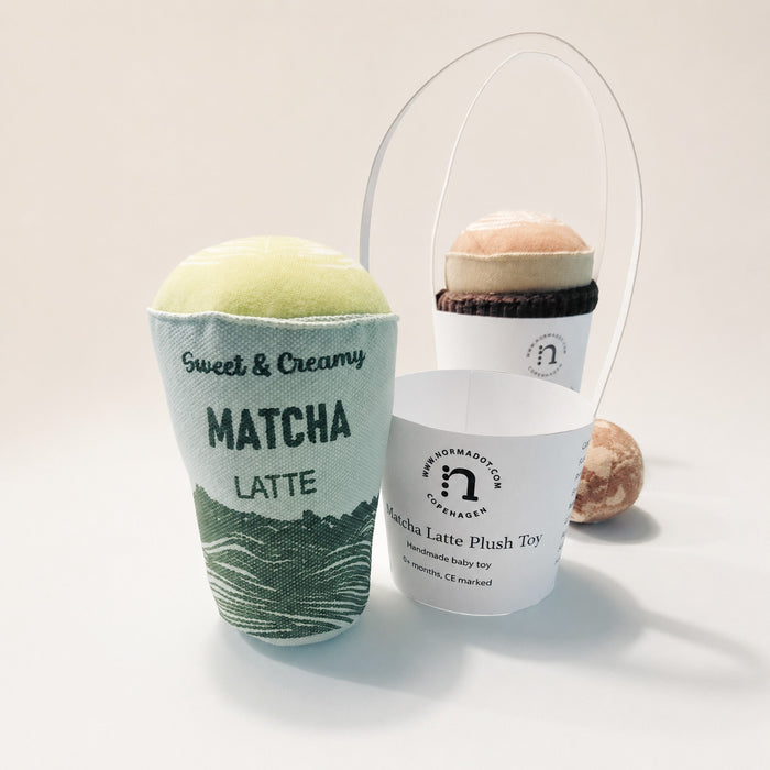 Handmade textile matcha latte plush toy with paper label, soft fabric cup, cappuccino cup and cookie, hand-printed and sewn in Denmark for pretend café play.