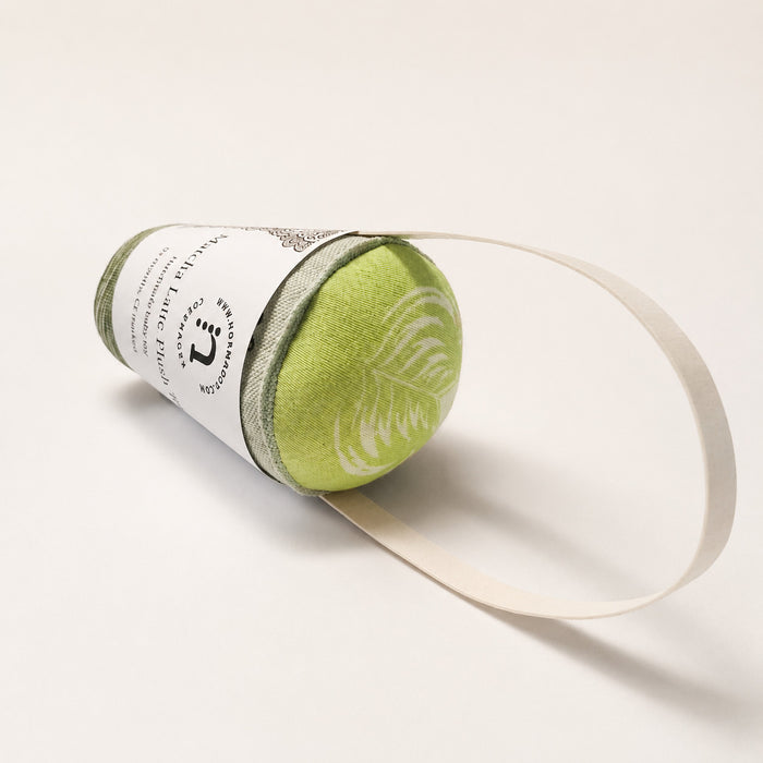 Handmade fabric matcha latte play food with soft green textile top, printed cup detail and cotton strap on a light studio background.