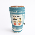 Fabric coffee cup Pillow with decorative pattern and text on a white background
