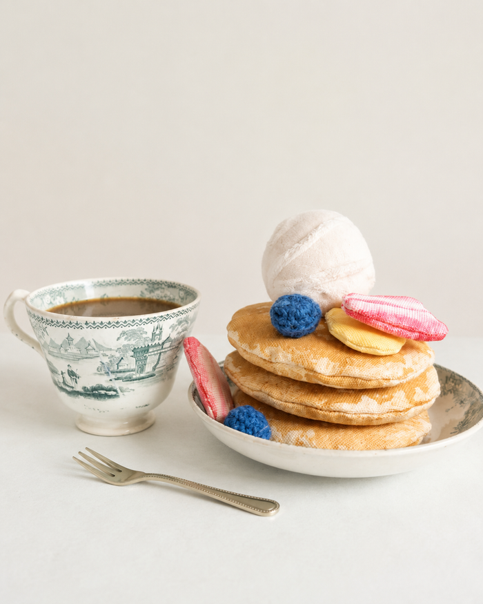 Handmade pancake play food set with soft fabric pancakes, fruit toppings, whipped cream, toy cup and small fork styled for pretend play kitchens