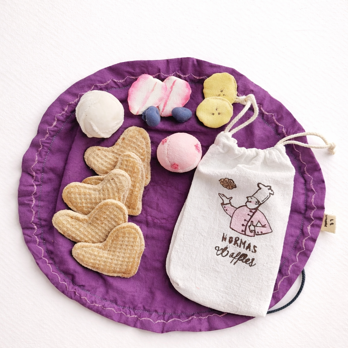 Purple mat with heart-shaped waffles, ice cream and fruit pretend play fabric toys  on a white background