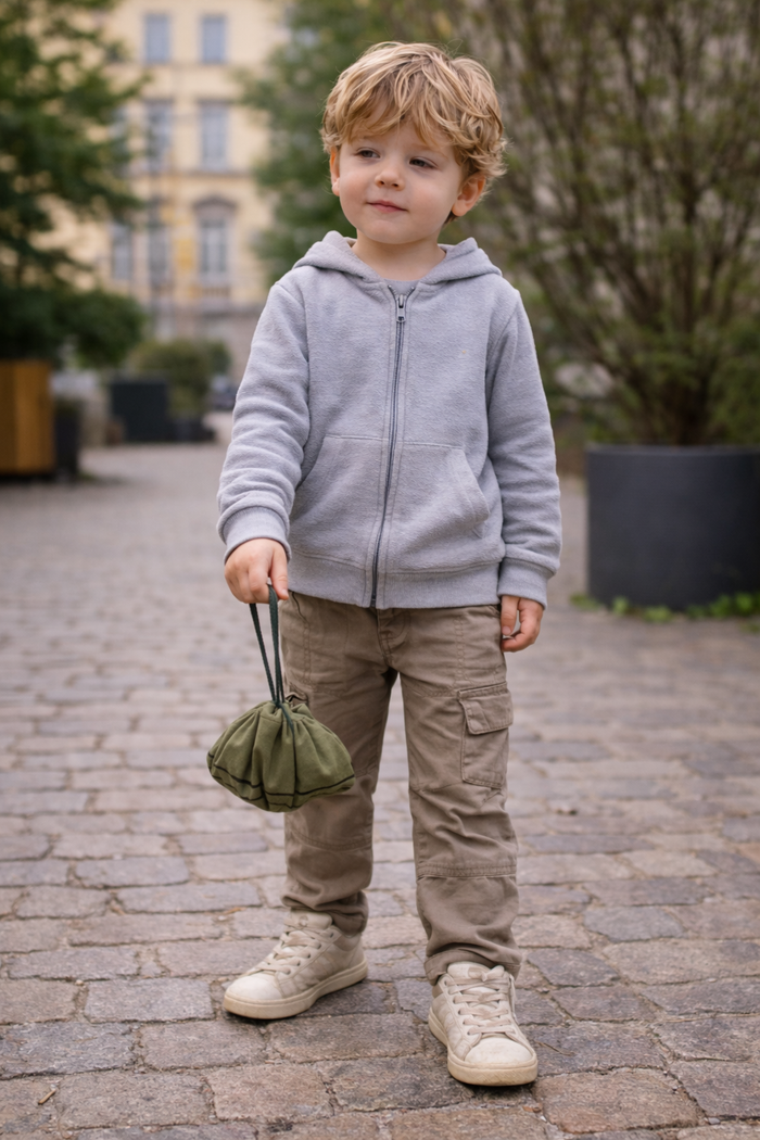 Child with a handmade fabric waffle play set in a storage bag