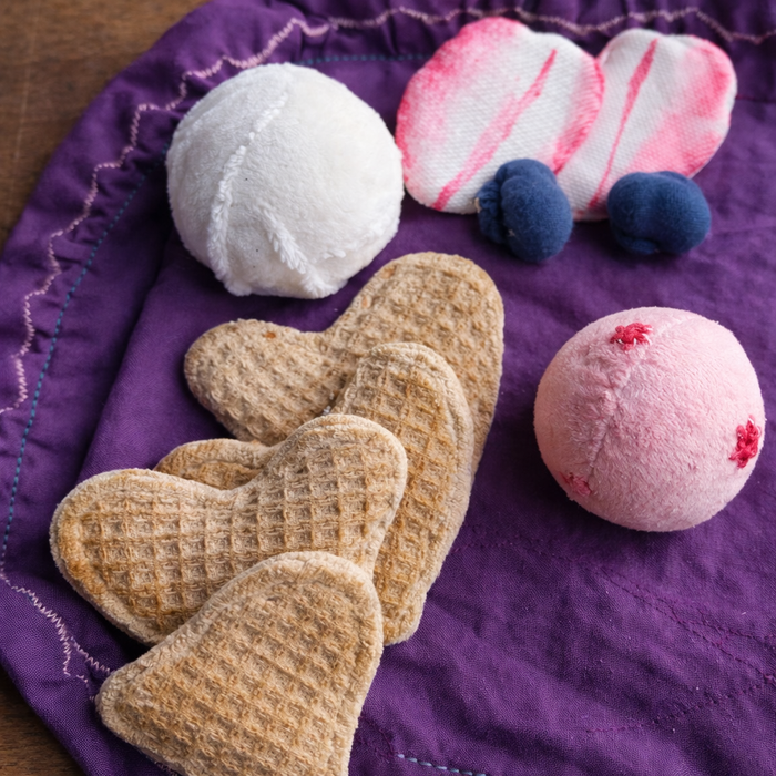 Heart-shaped fabric waffle play set on a purple fabric background